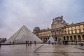 View of famous Louvre Museum and gallery with Louvre Pyramid in Paris France