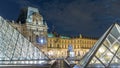 View of famous Louvre Museum with Louvre Pyramid at night timelapse . Paris, France Royalty Free Stock Photo