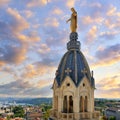 View of famous Marie statue on top of Notre-dame-de-fourviere basilica in Lyon at sunset Royalty Free Stock Photo