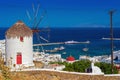 View of the famous Mykonos windmill above port and Mykonos town