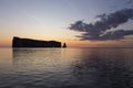 View of the famous PercÃÂ© rock with its hole illuminated by a beautiful summer orange sunrise