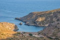 View of the famous rocky beach Melidoni in Kythira island at sunset. Amazing scenery with crystal clear water and a small rocky Royalty Free Stock Photo