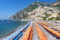 View of famous rows of blue and orange beach umbrellas on Positano Beach, Amalfi Coast, Italy