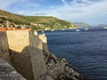 A view of the famous walls of Dubrovnik, which encircle the old town of Dubrovnik, Croatia with the adriatic sea in the distance