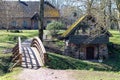 view of a farm with a house and a wooden bridge over the river Royalty Free Stock Photo