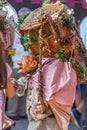 View of farmer doll, manipulated with people inside, carrying large traditional basket, at the Medieval market of Canas
