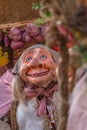 View of farmer doll, manipulated with people inside, carrying large traditional basket, at the Medieval market of Canas