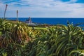 View of Farol da Ponta da Ferraria lighthouse from Miradouro da Ilha Sabrina, Sao Miguel Island, Azores, Portugal Royalty Free Stock Photo