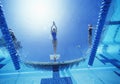 View of female swimmer diving in swimming pool