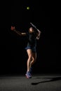 view on female tennis player with tennis racket bouncing to hit yellow tennis ball. Royalty Free Stock Photo