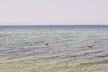 View of fenced area with buoys of sea coast of Mediterranean sea beach for safe swimming. Royalty Free Stock Photo