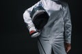 View of fencer holding fencing mask