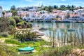 View on the Ferragudo, Lagoa, Algarve across the river Arade and many fishing boats in the foreground Royalty Free Stock Photo