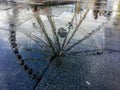 View of a ferris wheel with its image reflected