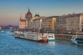 View of ferry in the Danube river and the parliament building in the background in the center of Budapest, Hungary Royalty Free Stock Photo