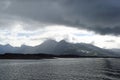 Grey and rainy clouds over the mountains of Helgeland archipelago Royalty Free Stock Photo