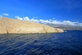 View from ferry to rocky part of Island Rab and Velebit mountain in background