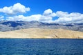 View from ferry to rocky part of Island Rab and Velebit mountain in background