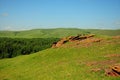 A view of the fertile valley and the edge of a gentle mountain from the top of a high hill