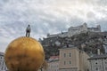 View of Festung Hohensalzburg in winter. Modern statue at Kapitelplatz.