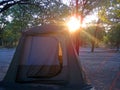 SUNBURST ABOVE TENT IN A CAMP IN THE AFRICAN BUSH Royalty Free Stock Photo