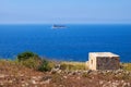 The view of Filfla islet with the guard building on the foreground.