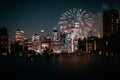 View of financial district Manhattan buildings and lights at night with fireworks at the sky Royalty Free Stock Photo