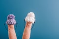 View of fingers as cheerful women in knitted hats isolated on blue