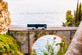 View on Fiordo di Furore arc bridge built between high rocky cliffs above the Tyrrhenian sea bay in Campania region. Bus driving Royalty Free Stock Photo