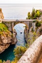 View on Fiordo di Furore arc bridge built between high rocky cliffs above the Tyrrhenian sea bay in Campania region. Car driving Royalty Free Stock Photo