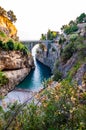 View on Fiordo di Furore arc bridge built between high rocky cliffs above the Tyrrhenian sea bay in Campania region. Curved Royalty Free Stock Photo