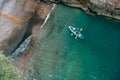 A view of the Fiordo of Furore in Amalfi coast, Travel and vacation concept. Tourists swim in a kayak on an excursion. Top down