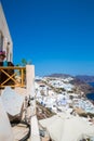 View of Fira town - Santorini island,Crete,Greece. White concrete staircases leading down to beautiful bay with clear blue sky and