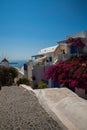 View of Fira town - Santorini island,Crete,Greece. White concrete staircases leading down to beautiful bay with clear blue sky and Royalty Free Stock Photo