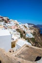 View of Fira town - Santorini island,Crete,Greece. White concrete staircases leading down to beautiful bay with clear blue sky and Royalty Free Stock Photo