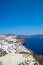 View of Fira town - Santorini island,Crete,Greece. White concrete staircases leading down to beautiful bay with clear blue sky and Royalty Free Stock Photo