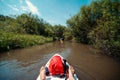 View from the first person. A trip on a SAP board. A narrow river in the middle of the forest, an extreme route. bag with water