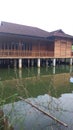 a view of a fish pond where there is a wooden house