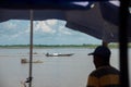 View of a fisherman`s boat with a person on the banks of the Magdalena River. Colombia.