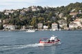 View of a fishing boat passing on Bosphorus and Bebek neighborhood on European side of Istanbul.