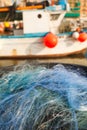 A view of a fishing net in front of the boat on the beach. Beautiful calm sea and water during an hot summer day Royalty Free Stock Photo