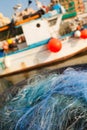 A view of a fishing net in front of the boat on the beach. Beautiful calm sea and water during an hot summer day Royalty Free Stock Photo