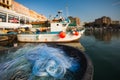 A view of a fishing net in front of the boat on the beach. Beautiful calm sea and water during an hot summer day Royalty Free Stock Photo