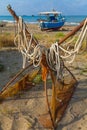 A view of a fishing net in front of the boat on the beach. Beautiful calm sea and water during an hot summer day Royalty Free Stock Photo