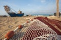 A view of a fishing net in front of the boat on the beach. Beautiful calm sea and water during an hot summer day Royalty Free Stock Photo