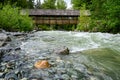 View from Fitzsimmons Creek of covered wooden bridge over the river, Whistler, BC, Canada