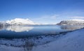 View at the fjord in the Atlantic Ocean with a snowy field in the polar area and mountains covered in snow near Tromso Norway Royalty Free Stock Photo
