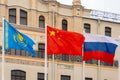 Flags of China, Russia, and Kazakhstan on a background of building Royalty Free Stock Photo