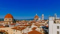 Florence Cathedral, Giotto`s Bell Tower, and San Lorenzo Basilica under blue sky, over houses of the historical center of Florenc