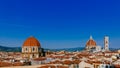 Florence Cathedral, Giotto`s Bell Tower, and San Lorenzo Basilica under blue sky, over houses of the historical center of Florenc